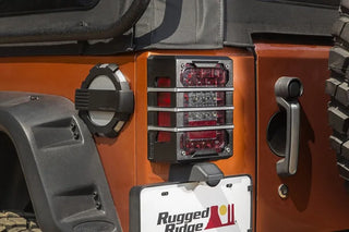Rugged Ridge Brushed Black Elite Tail Light Guards: Fits Most Jeep Wrangler Models (2007-2018)